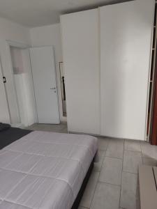 a bedroom with two large white closets and a bed at Ca' de' Mari at Como - Switzerland - Private Parking - Self Check-In in Faloppio
