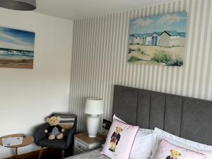 a bedroom with a bed and a chair with a teddy bear at Seacrest B&B in Galway