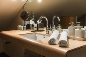 a bathroom counter with a sink and two faucets at Hotel Villa Will in Hannover +42 photos