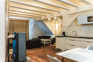 a kitchen and a living room with a couch and a table at Hotel Villa Will in Hannover