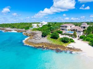 an aerial view of a house on a beach at Sandcastle Beach House in The Valley
