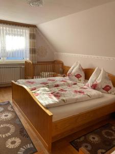 a bedroom with a large bed with flowers on it at Gross Lettenwag in Göstling an der Ybbs