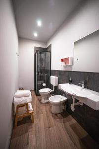 a bathroom with two sinks and a toilet and a shower at Chivasso centro - Garden Apartments in Chivasso