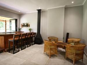 a room with a bar with chairs and a wooden table at The Roaming Goat Guesthouse in Toekoms +45 photos