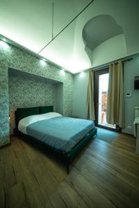 a bedroom with a bed and a large window at Chivasso centro - Garden Apartments in Chivasso