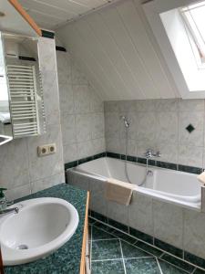 a bathroom with a tub and a sink at Gross Lettenwag in Göstling an der Ybbs