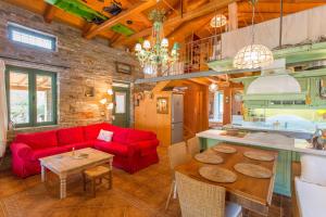 a living room with a red couch and a table at villapetramarina in Tsakaíoi