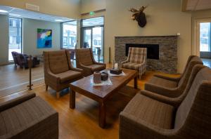 a living room with chairs and a fireplace at Dombås Hotel in Dombås
