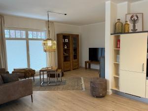 a living room with a couch and a table at Villa Strandleben in Zingst