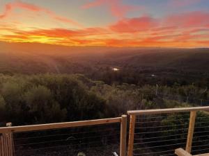 a view of a sunset from the deck of a house at Blissful Barons View in Plettenberg Bay