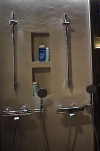 a shower stall with two stalls with a drink on the wall at Levi Lakeview Ahvenranta in Kittilä +14 photos
