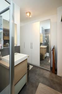 a bathroom with a white sink and a mirror at Art-inn in San Vendemiano +27 photos
