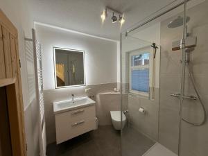 a bathroom with a toilet and a sink and a shower at Villa Strandleben in Zingst +14 photos