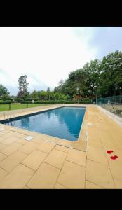 a swimming pool with blue water in a park at Chill & Nature in Nargis