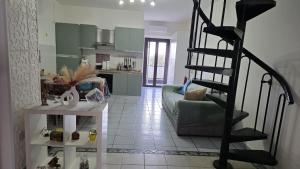 a living room with a spiral staircase leading to a kitchen at Casa Rosa in Rocca San Giovanni +2 photos