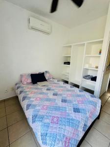 a bedroom with a bed with a laptop on it at Casa completa en Acapulco in Acapulco