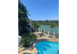arial view of a swimming pool and a lake at Mango Villa Mtwapa in Mtwapa