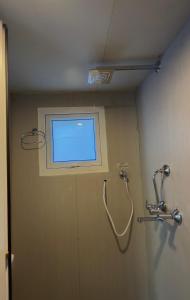 a bathroom with a window and a shower at Phakding Camp One Lodge in Phakding