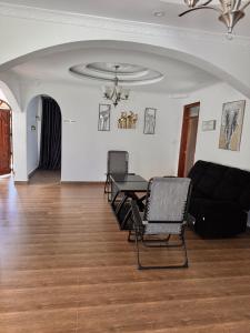 a living room with a table and chairs and a couch at NAIBERi LUXURY HOME in Eldoret