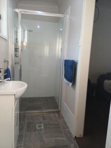 a bathroom with a shower and a sink at Wattleview in Lithgow