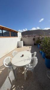 a white table and chairs on a patio at Résidence chez Said in Sidi Ifni