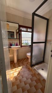 a bathroom with a shower and a toilet and a sink at Résidence chez Said in Sidi Ifni +18 photos