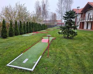 a garden with a golf course in the grass at Łebska Ostoja - Zacisze in Żarnowska