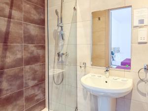 a bathroom with a sink and a shower at Island Guesthouse in Il-Gżira +27 photos