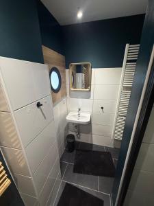 a small bathroom with a sink and a mirror at stayOldenburg in Oldenburg