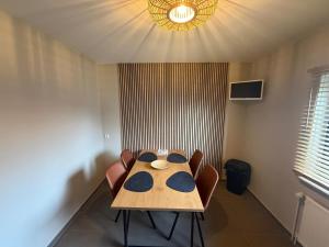 a table and chairs in a room with a light at stayOldenburg in Oldenburg