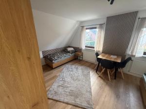 a small room with a bed and a table and chairs at stayOldenburg in Oldenburg