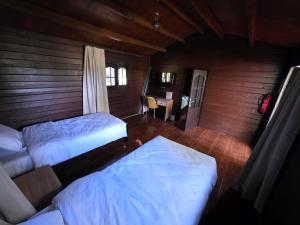 a bedroom with two beds and a table with a desk at Auberge RAMZ'S in Beni Mellal +8 photos