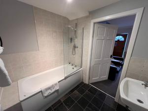 a bathroom with a tub and a sink at Pendle Inn in Barrowford +42 photos