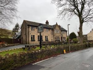 a building with picnic tables on the side of the road at Pendle Inn in Barrowford