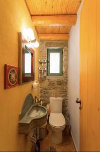 a bathroom with a toilet and a sink at villapetramarina in Tsakaíoi +49 photos