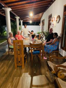 a group of people sitting around a table at Rupa Villa in Beruwala +28 photos