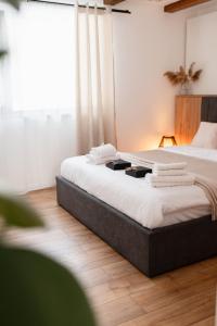 ein Schlafzimmer mit einem Bett, auf dem Handtücher liegen in der Unterkunft Arenis in Muntele Băişorii
