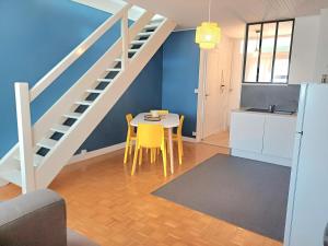 a kitchen and dining room with a table and a staircase at Le Loft - En Plein Centre Très Spacieux in Beauvais