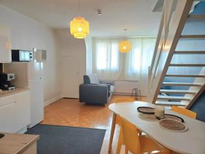 a kitchen and living room with a table and a staircase at Le Loft - En Plein Centre Très Spacieux in Beauvais +19 photos