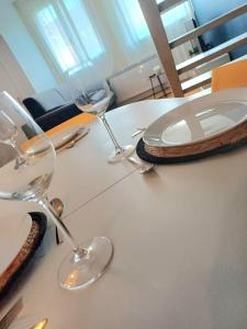 a white table with wine glasses and plates on it at Le Loft - En Plein Centre Très Spacieux in Beauvais