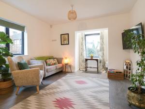 a living room with a couch and a table at The Kiln in Bolnhurst