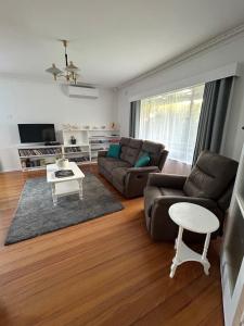a living room with a couch and a table at Genesta House in Cowes