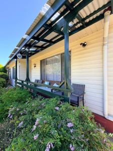 a porch with a pergola and benches on a house at Genesta House in Cowes