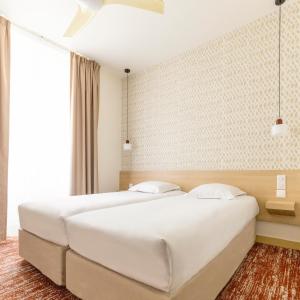 Llit o llits en una habitació de Hotel Gambetta