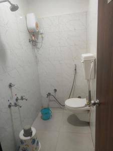 a bathroom with a toilet and a shower in it at kathiyawadi Hotel somnath in Kevdi Road