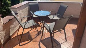 four chairs and a table on a balcony at BT Lux apartment 2 in Skopje