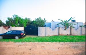 a car parked in front of a fence at New Star House in Arusha +2 photos