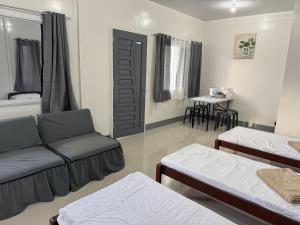 a living room with two beds and a couch at Helens Mountain Resort in Binungan