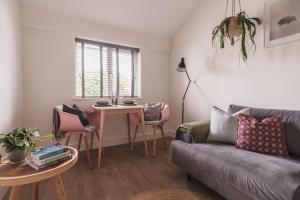 a living room with a couch and a table at Stylish accommodation - Bowness centre with parking space in Bowness-on-Windermere