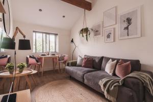 a living room with a couch and a table at Stylish accommodation - Bowness centre with parking space in Bowness-on-Windermere